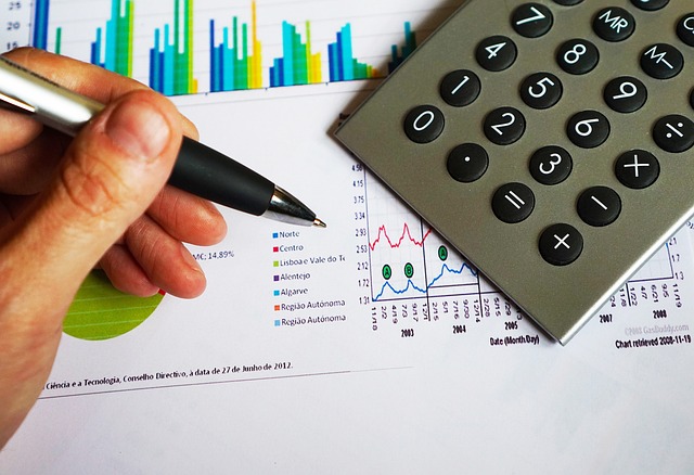 Preparing a financial statements on a desk with a calculator, documents